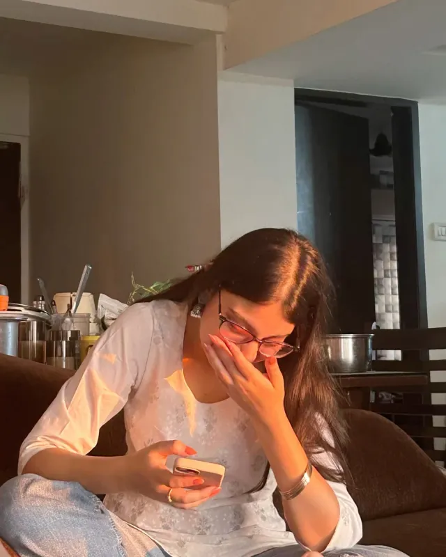 A girl laughing at a message on her phone
